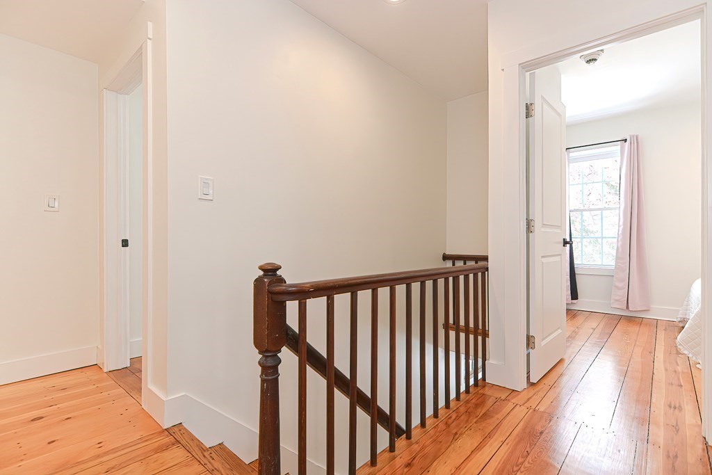 166 Littleton Road, Unit 1 Harvard, MA 01451 - Photo 11 of 23 a view of a hallway with wooden floor and staircase