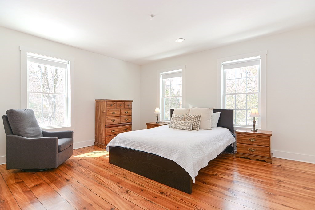 166 Littleton Road, Unit 1 Harvard, MA 01451 - Photo 12 of 23 a bedroom with a bed and a couch