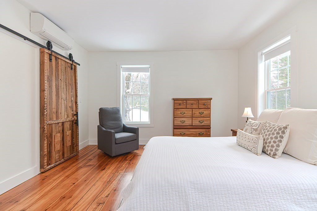 166 Littleton Road, Unit 1 Harvard, MA 01451 - Photo 13 of 23 a spacious bedroom with a bed and a couch