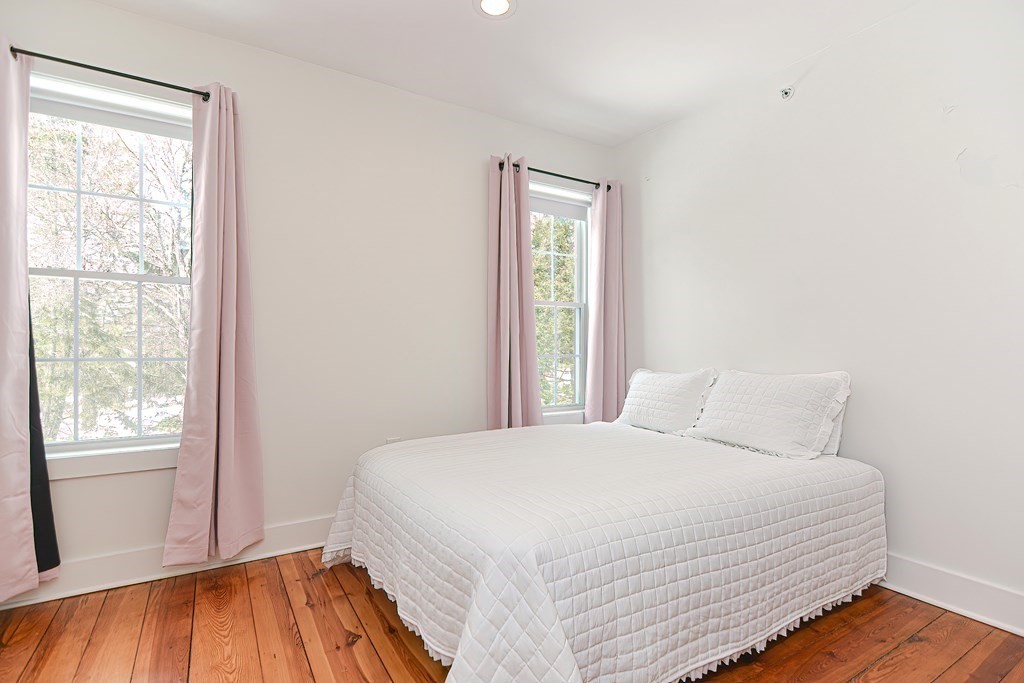 166 Littleton Road, Unit 1 Harvard, MA 01451 - Photo 14 of 23 a bedroom with a bed and a window