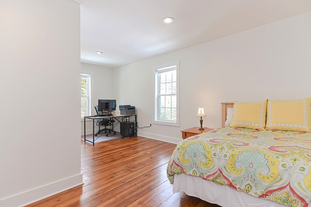 166 Littleton Road, Unit 1 Harvard, MA 01451 - Photo 15 of 23 a bedroom with a bed and wooden floor