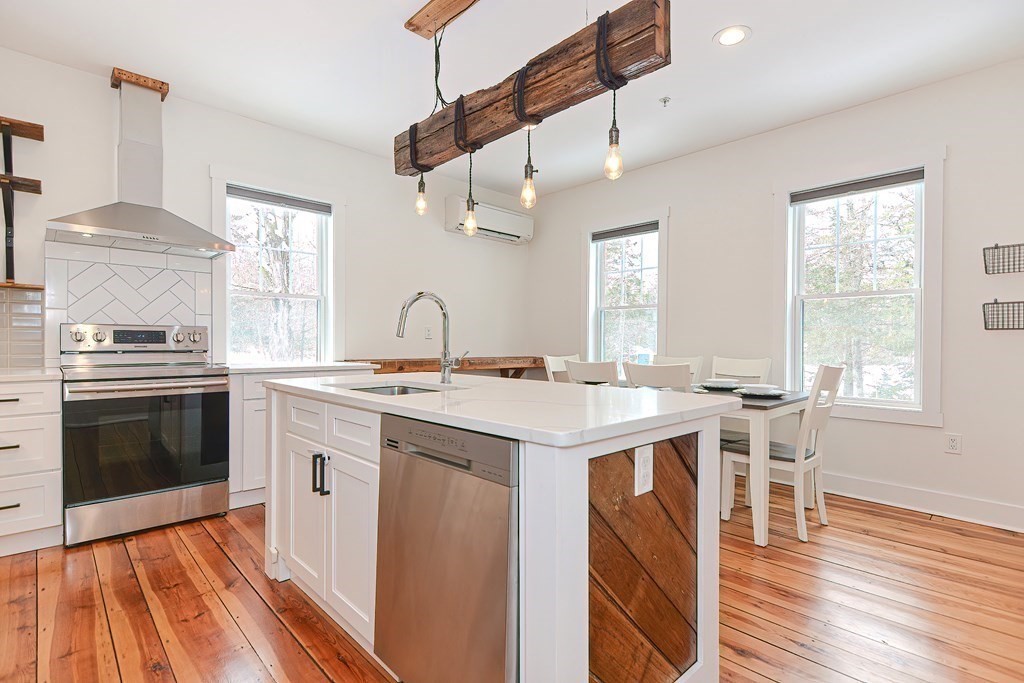 166 Littleton Road, Unit 1 Harvard, MA 01451 - Photo 2 of 23 a kitchen with a stove a sink and wooden floor