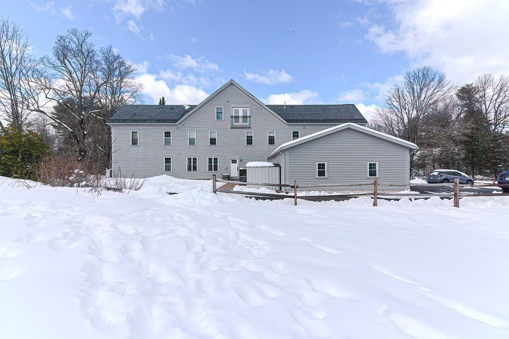 166 Littleton Road, Unit 1 Harvard, MA 01451 - Photo 21 of 23 a view of a house with a snow in the yard