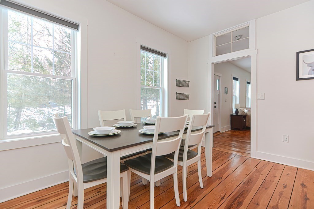 166 Littleton Road, Unit 1 Harvard, MA 01451 - Photo 3 of 23 a view of a dining room with furniture and wooden floor