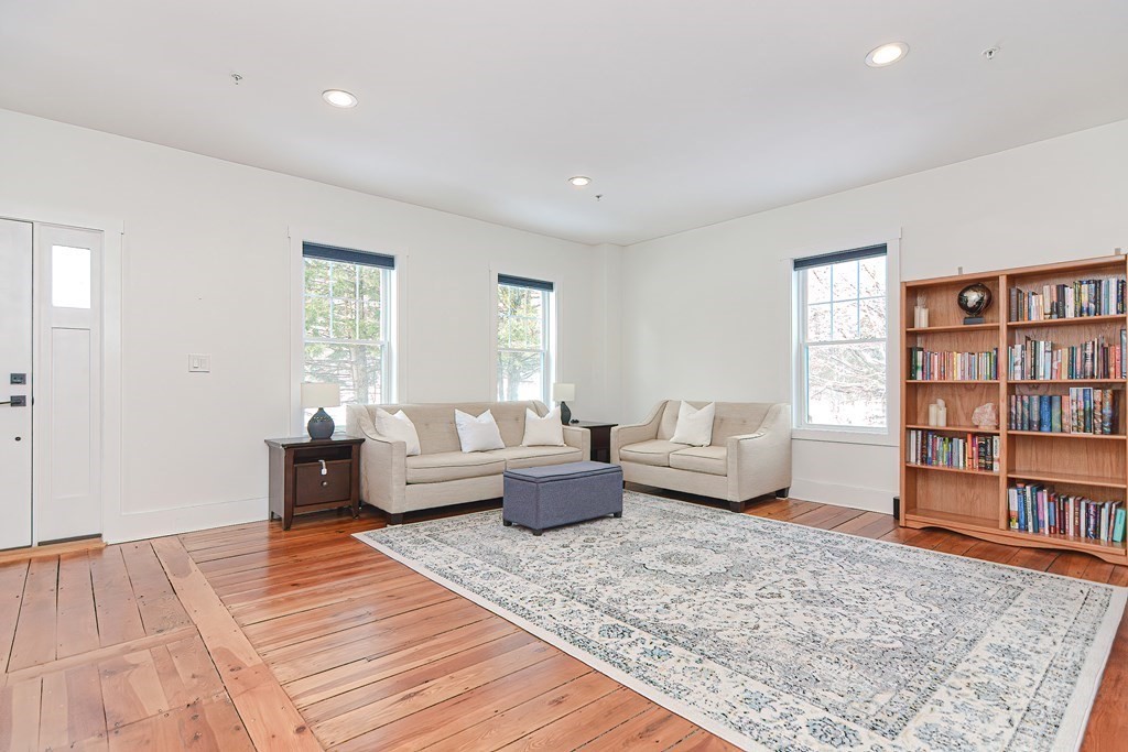 166 Littleton Road, Unit 1 Harvard, MA 01451 - Photo 7 of 23 a living room with furniture and a book shelf