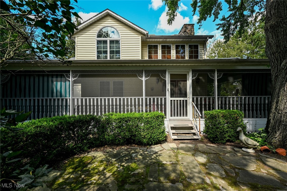 View of back of house featuring covered wrap around porch