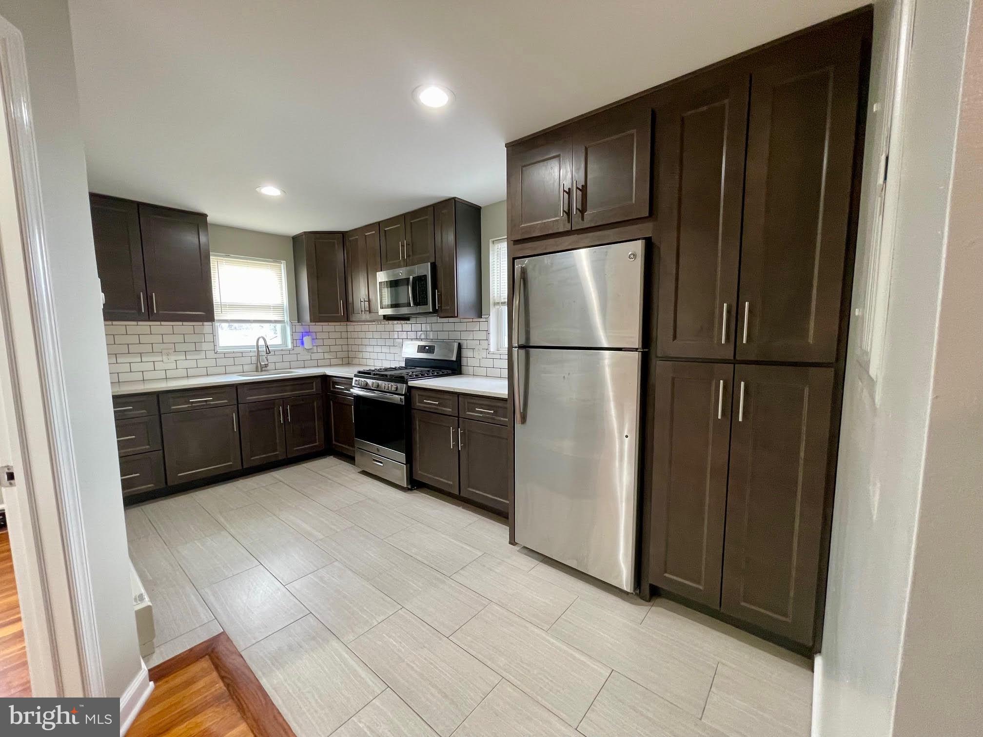 412 East Providence Road Aldan, PA 19018 - Photo 3 of 13 a kitchen with granite countertop stainless steel appliances a refrigerator and a sink