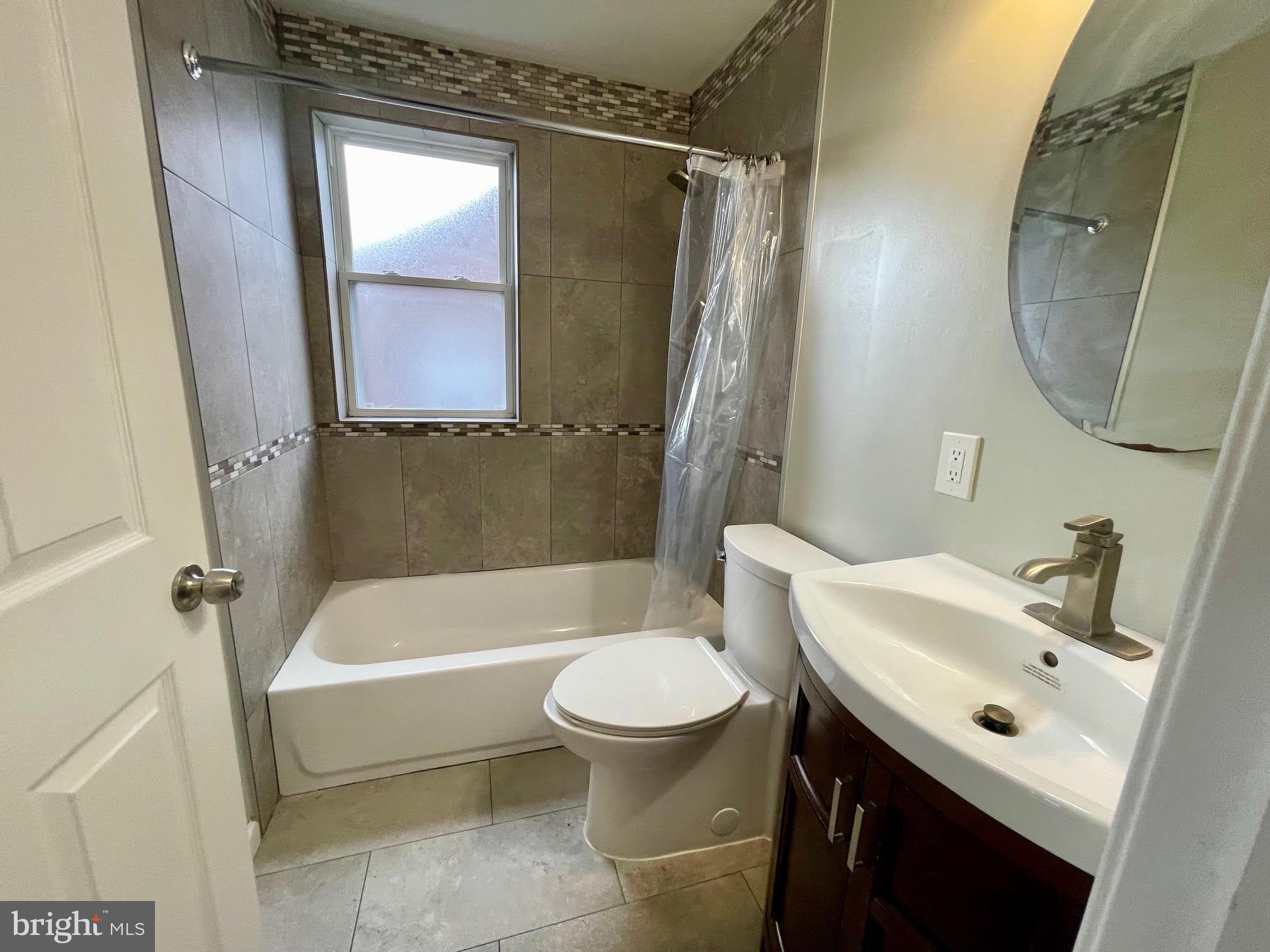 412 East Providence Road Aldan, PA 19018 - Photo 8 of 13 a bathroom with a sink a toilet and a mirror