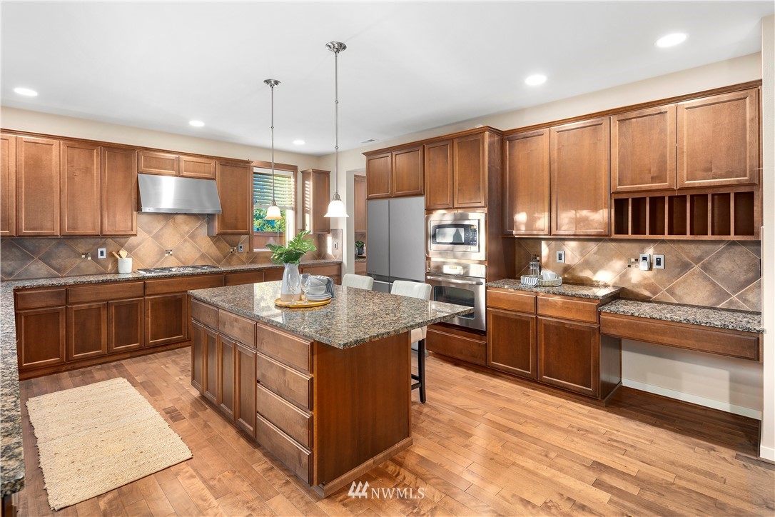 3714 215th Place Southeast Bothell, WA 98021 - Photo 12 of 37 a kitchen with stainless steel appliances granite countertop a stove a sink dishwasher a refrigerator and a oven with wooden floor