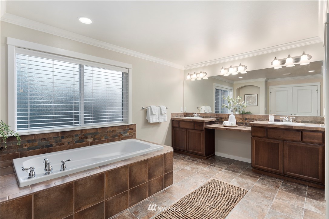 3714 215th Place Southeast Bothell, WA 98021 - Photo 25 of 37 a spacious bathroom with a granite countertop sink and a bathtub