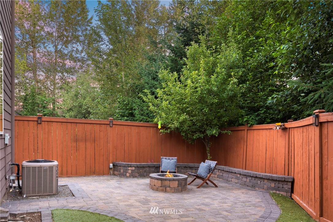 3714 215th Place Southeast Bothell, WA 98021 - Photo 35 of 37 a backyard with table and chairs and a barbeque