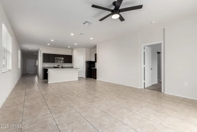 a view of a kitchen with a sink and a refrigerator
