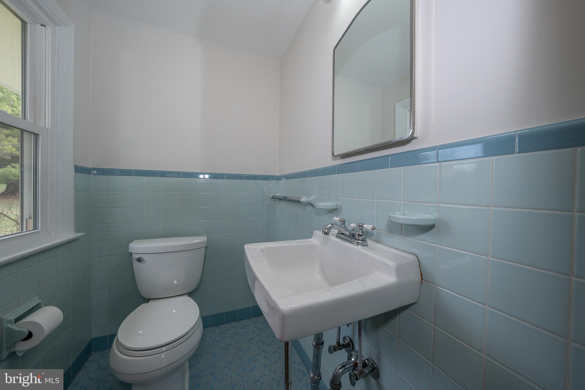 1435 North Trooper Road Methacton, PA 19403 - Photo 15 of 30 a bathroom with a toilet a sink and a window