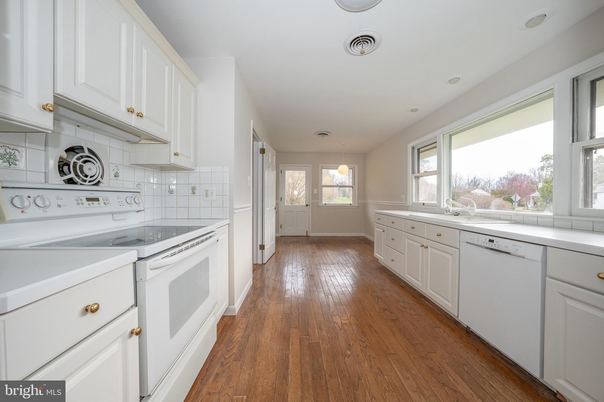 1435 North Trooper Road Methacton, PA 19403 - Photo 4 of 30 a open kitchen with granite countertop a stove top oven sink and cabinets