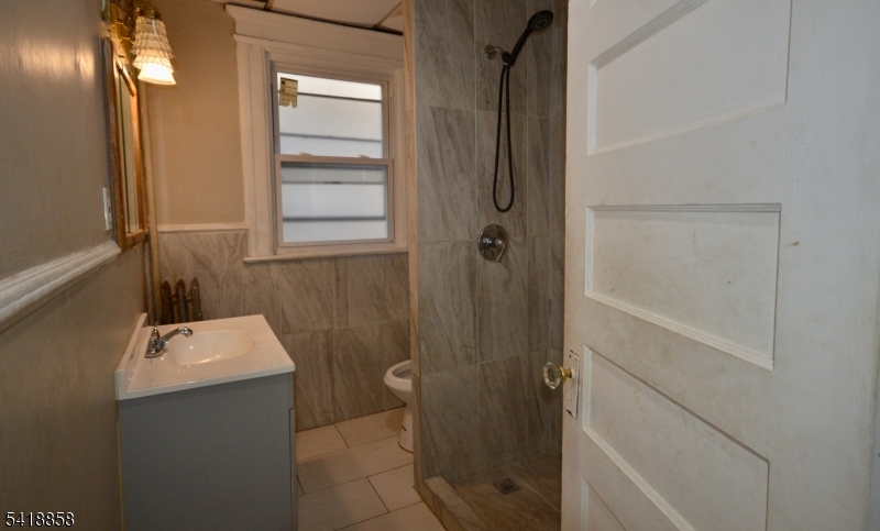 899 South 18th Street, Unit 1 Newark, NJ 07108 - Photo 15 of 23 a bathroom with a sink and shower