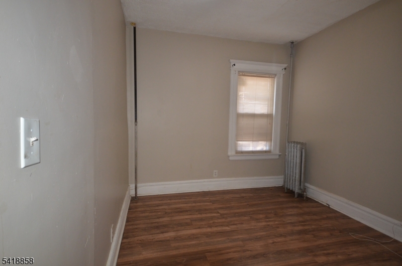 899 South 18th Street, Unit 1 Newark, NJ 07108 - Photo 22 of 23 a view of an empty room with wooden floor and a window
