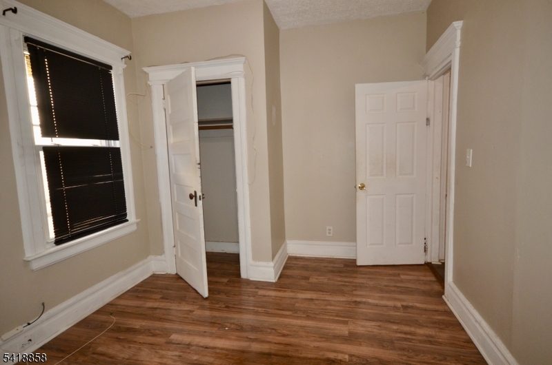 899 South 18th Street, Unit 1 Newark, NJ 07108 - Photo 23 of 23 a view of an empty room with wooden floor and closet