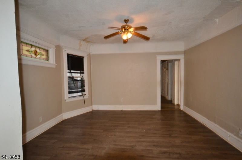 899 South 18th Street, Unit 1 Newark, NJ 07108 - Photo 5 of 23 a view of an empty room with a window and wooden floor