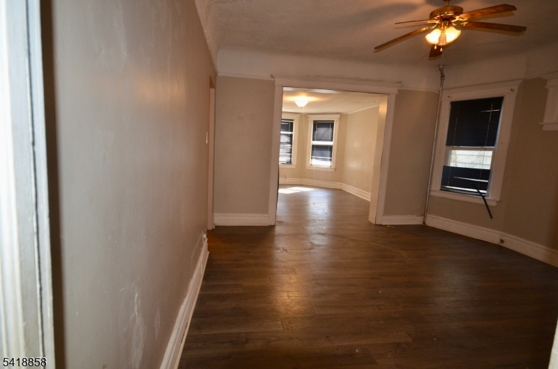 899 South 18th Street, Unit 1 Newark, NJ 07108 - Photo 6 of 23 a view of an empty room with wooden floor and a window