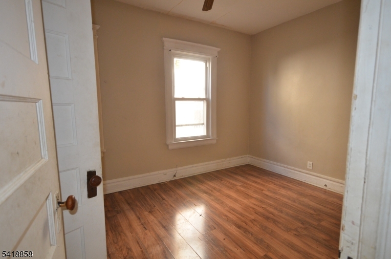 899 South 18th Street, Unit 1 Newark, NJ 07108 - Photo 8 of 23 an empty room with wooden floor and windows