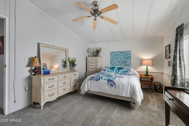 a bedroom with a bed and a dresser