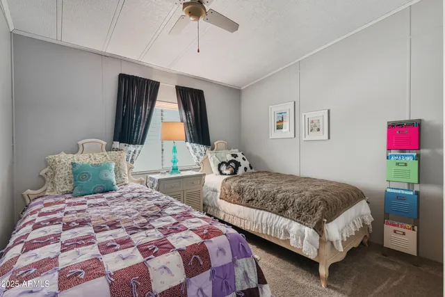 a bedroom with two beds and a chandelier