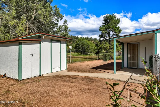 a view of a house with a yard and potted plants