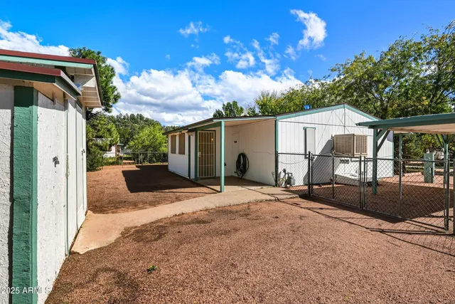 a patio with table and chairs and potted plants