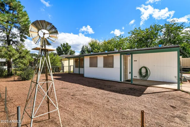 a backyard of a house with portable swimming pool table and chairs