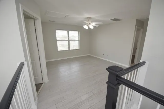 wooden floor in an empty room with a mirror