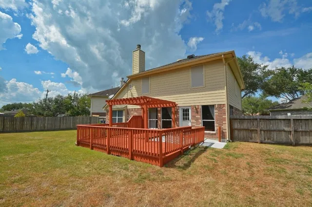 a view of a house with a yard and sitting area