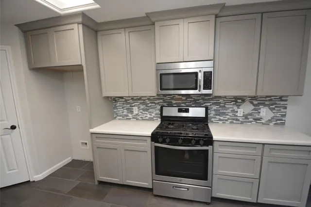 a kitchen with cabinets stainless steel appliances and wooden cabinets