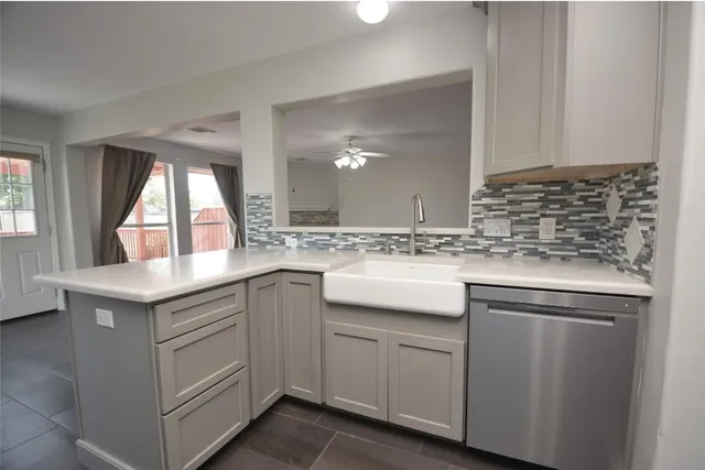 a kitchen with sink cabinets and window