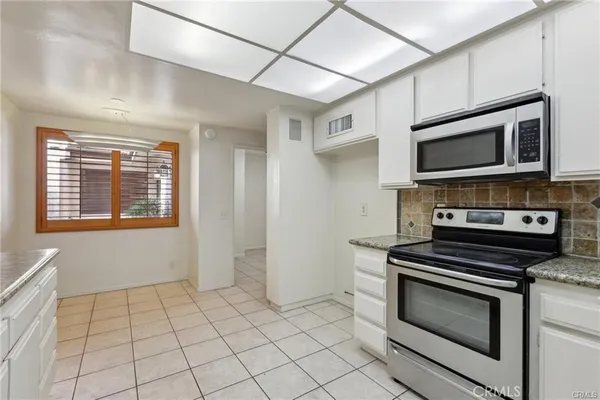 a view of a room with wooden floor and a window
