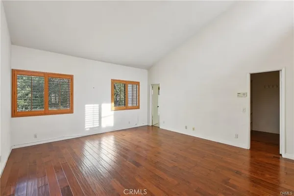a view of a room with wooden floor and brick walls