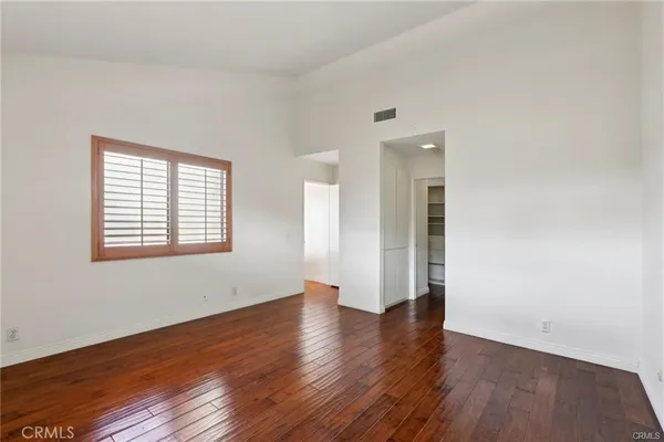 a view of a room with wooden floor and a window