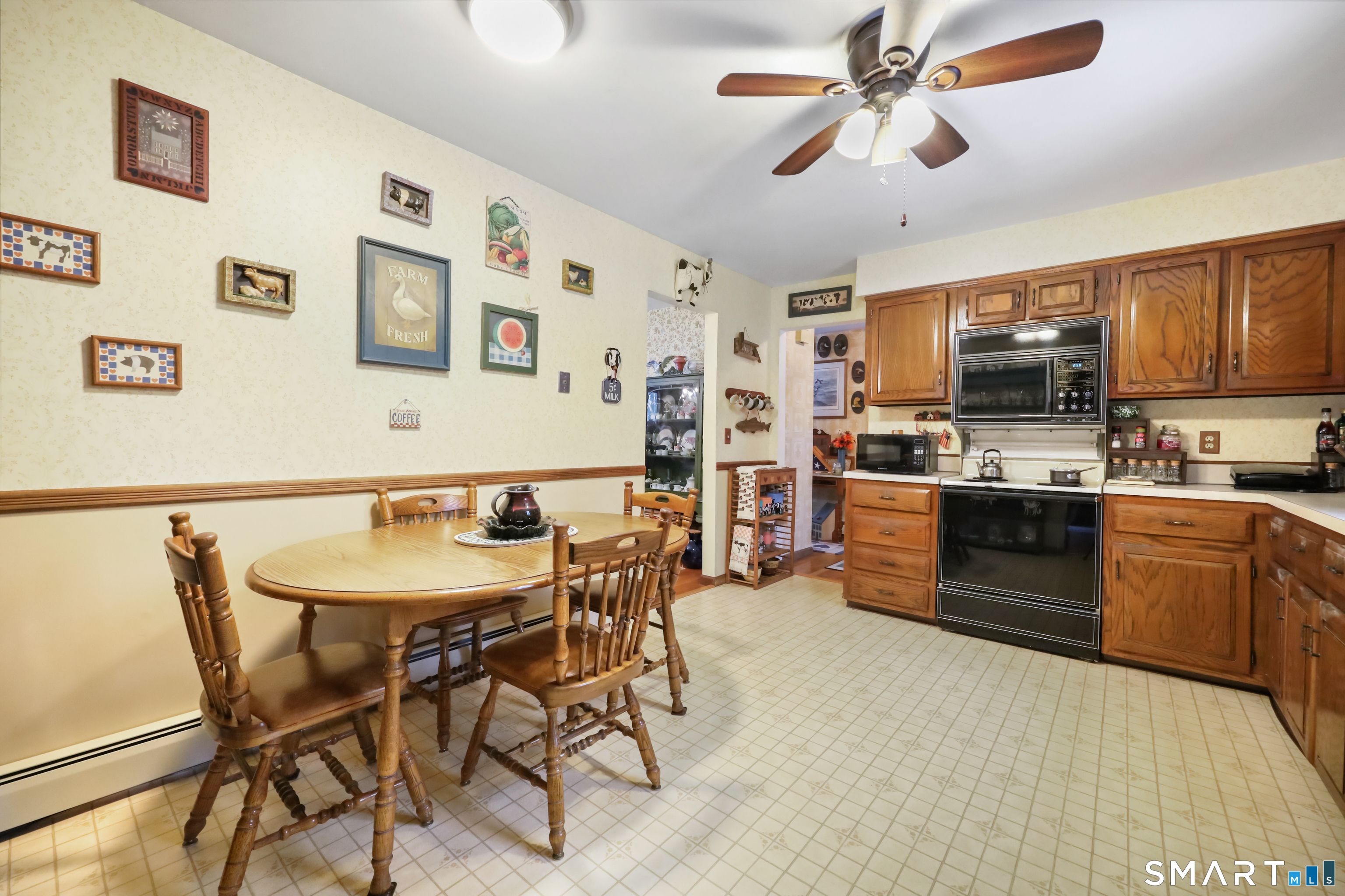 429 Rock House Road Redding, CT 06896 - Photo 11 of 26 a kitchen with stainless steel appliances kitchen island granite countertop a dining table and chairs