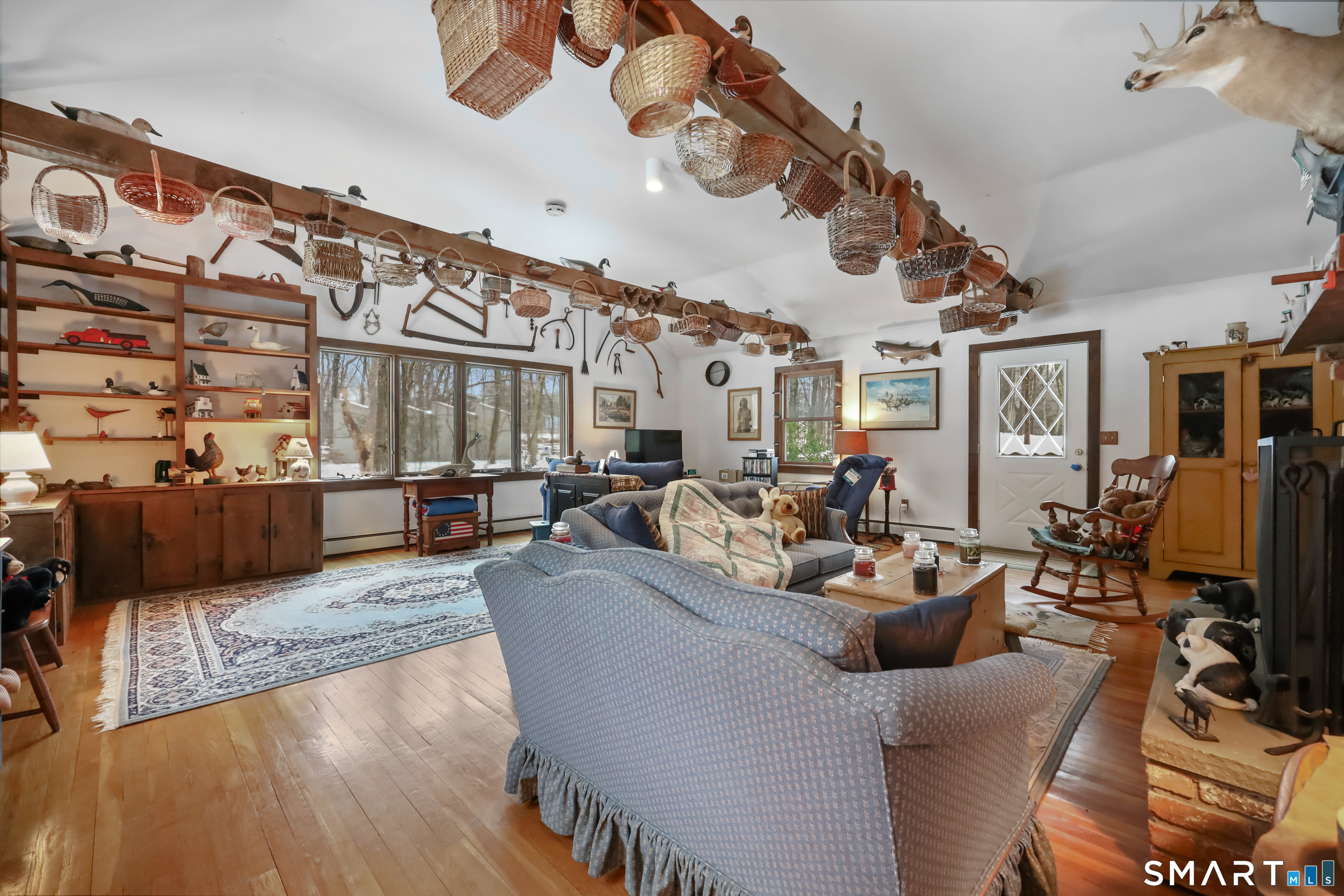 429 Rock House Road Redding, CT 06896 - Photo 12 of 26 a living room with fireplace furniture and a flat screen tv