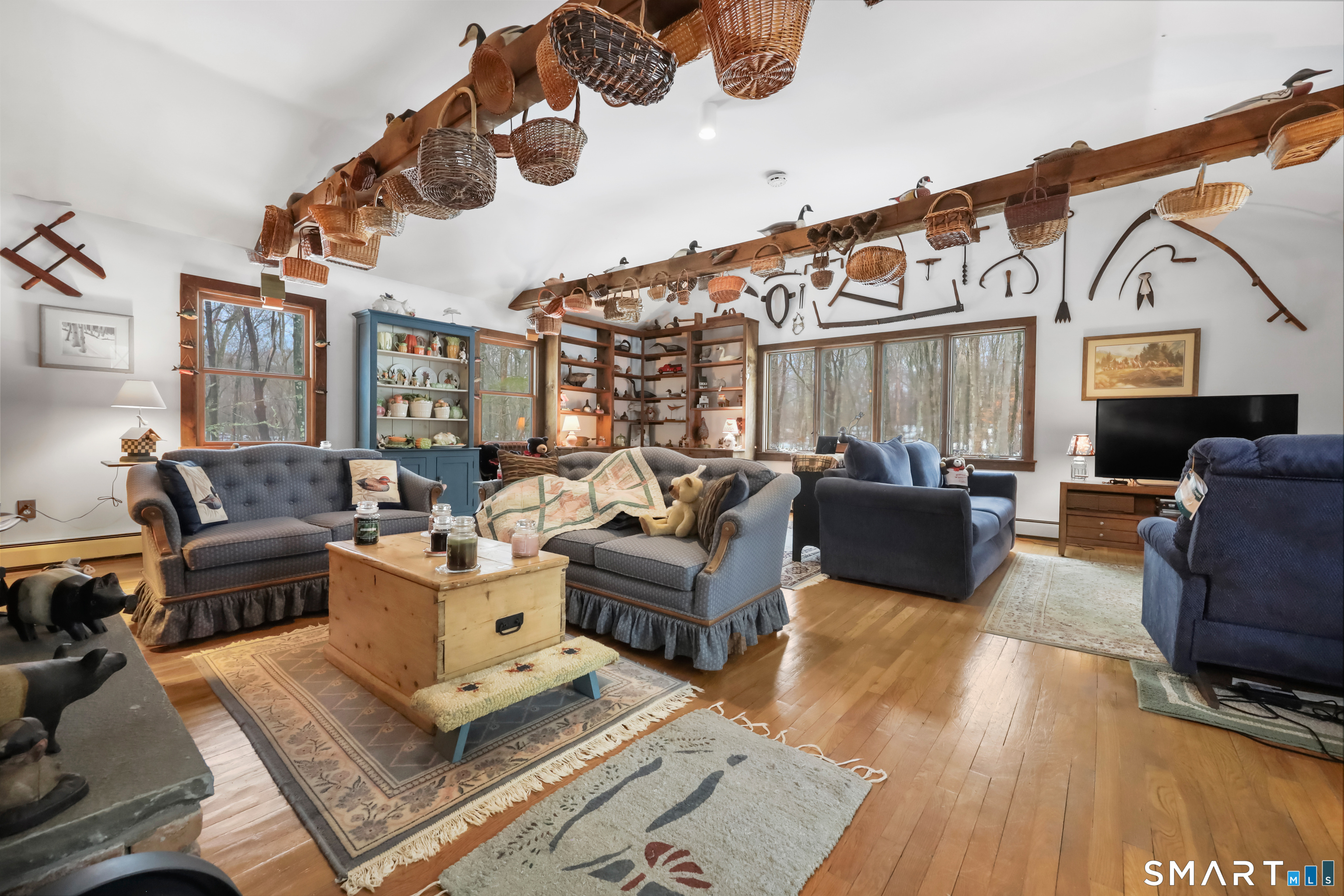 429 Rock House Road Redding, CT 06896 - Photo 14 of 26 a living room with furniture ceiling fan and a rug