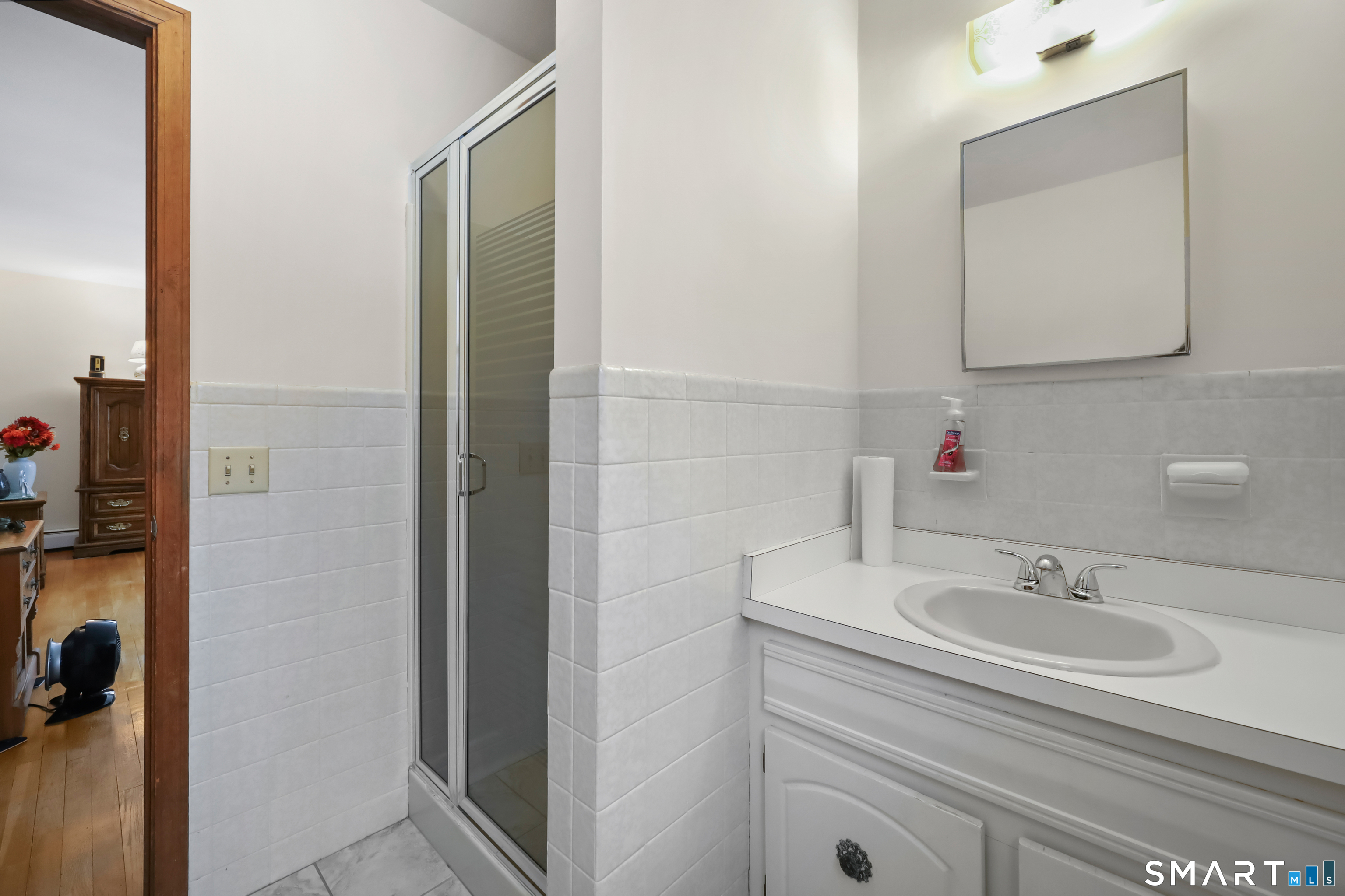 429 Rock House Road Redding, CT 06896 - Photo 19 of 26 a bathroom with a sink and a mirror