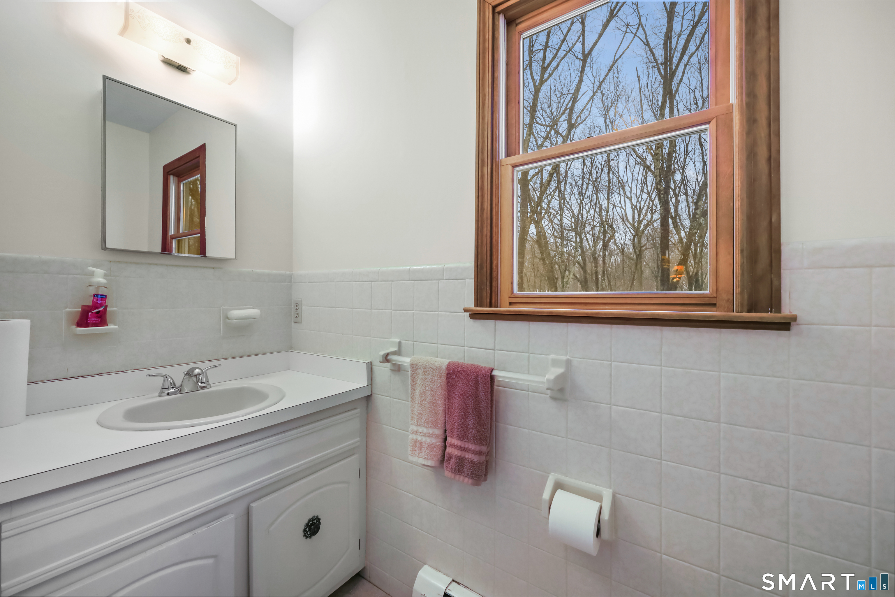 429 Rock House Road Redding, CT 06896 - Photo 20 of 26 a bathroom with a sink mirror and vanity