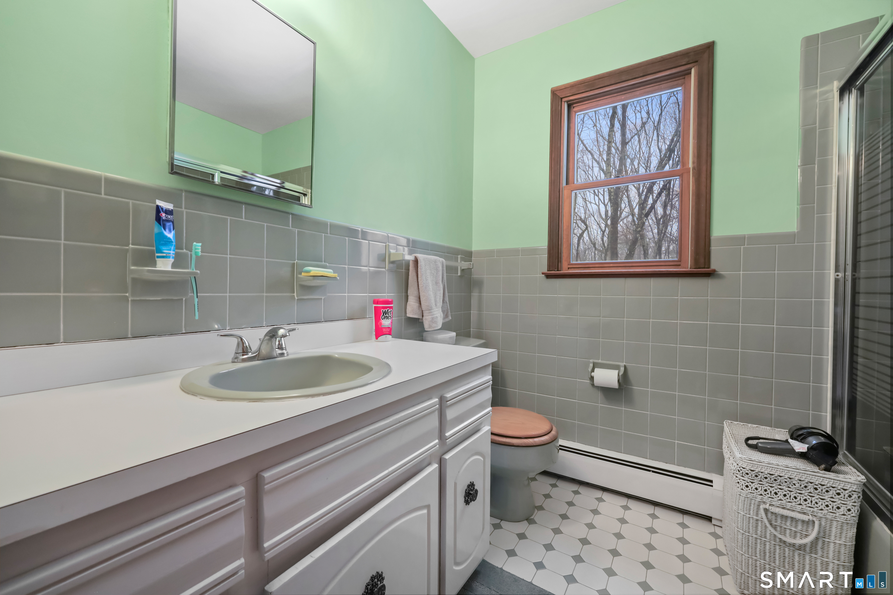 429 Rock House Road Redding, CT 06896 - Photo 23 of 26 a bathroom with a granite countertop toilet a sink and a mirror