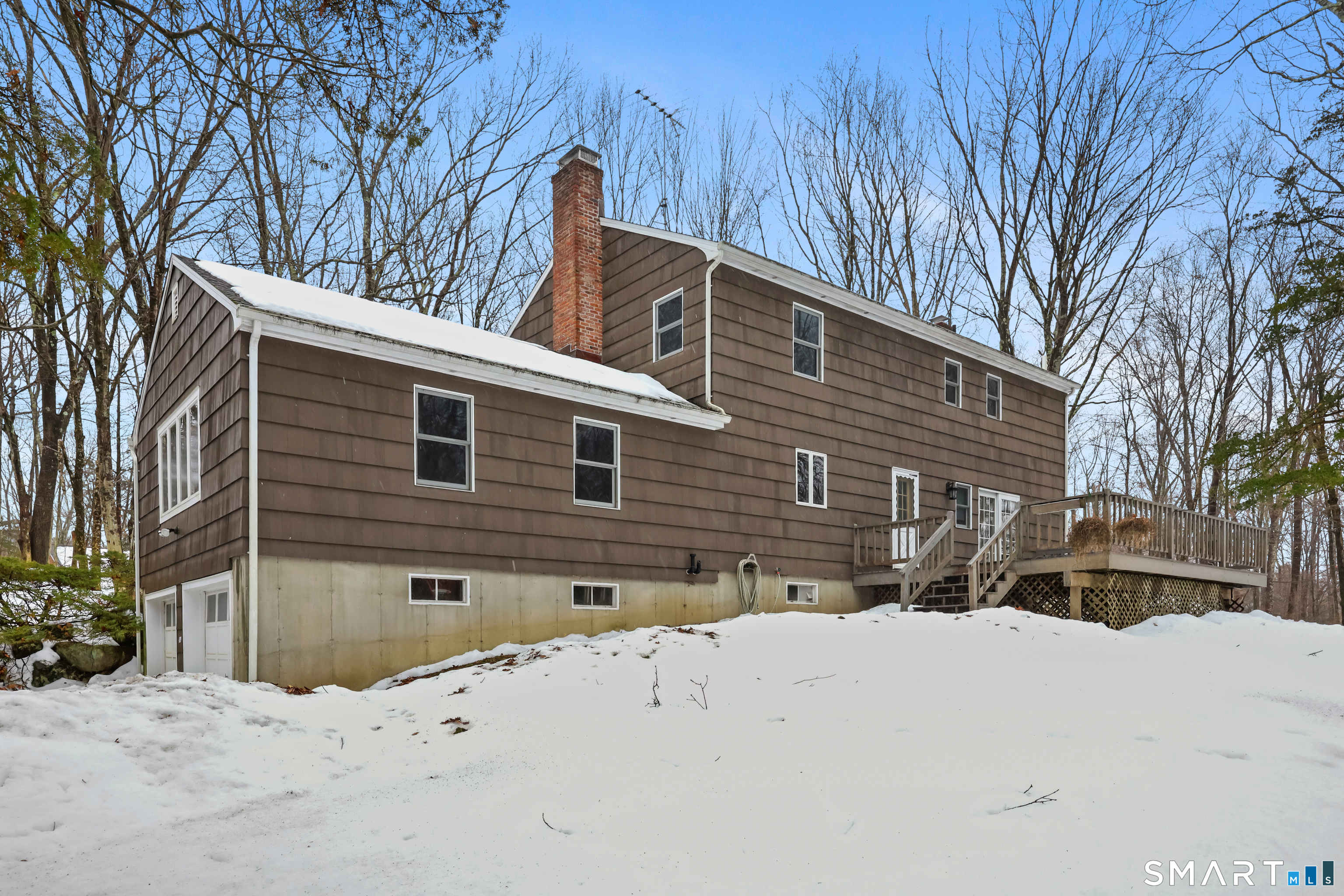 429 Rock House Road Redding, CT 06896 - Photo 8 of 26 a front view of a house with a yard covered in snow