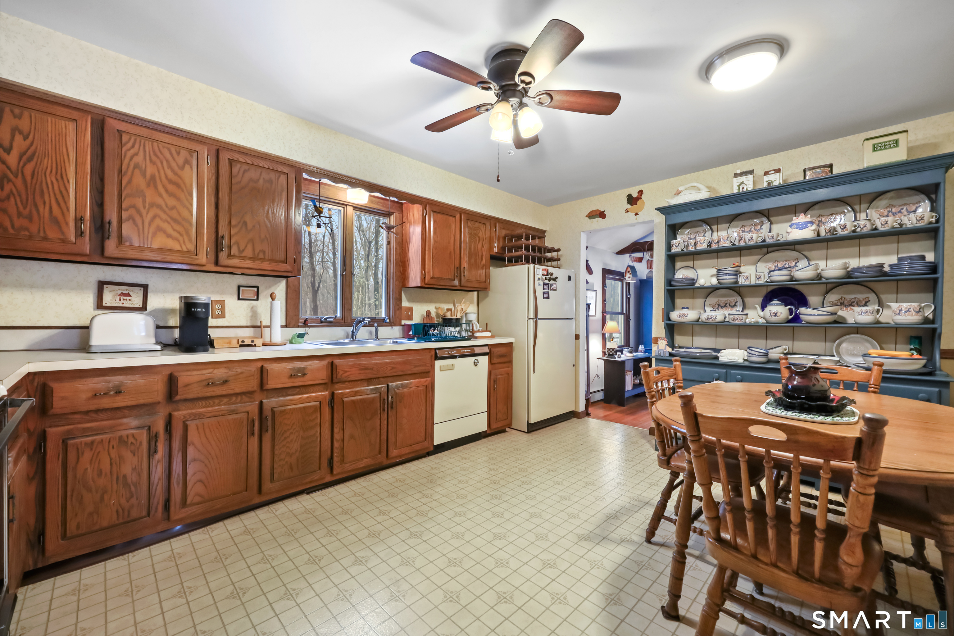 429 Rock House Road Redding, CT 06896 - Photo 9 of 26 a kitchen with stainless steel appliances granite countertop a stove a sink dishwasher and a refrigerator with wooden cabinets