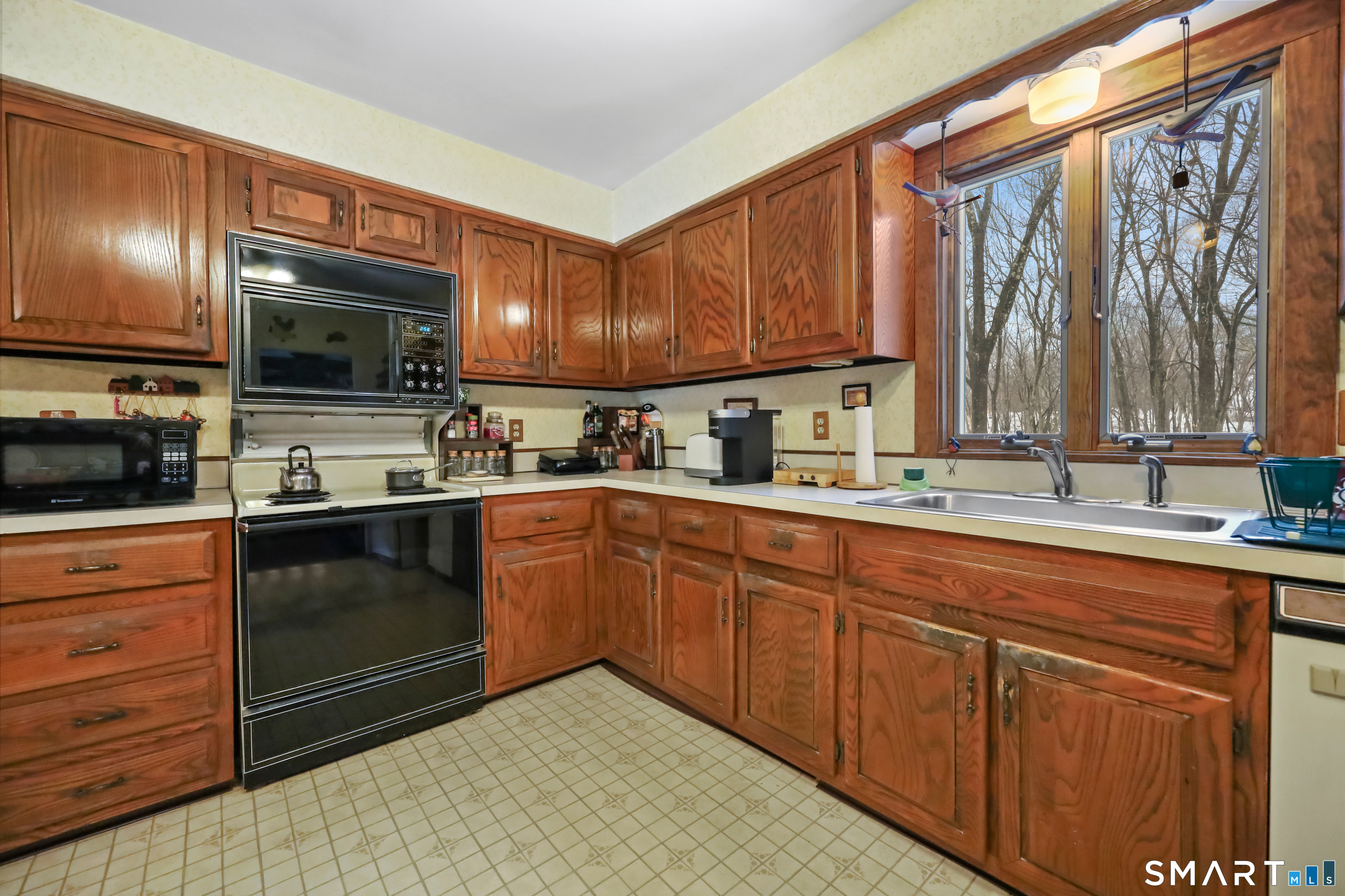 429 Rock House Road Redding, CT 06896 - Photo 10 of 26 a kitchen with a sink microwave and cabinets