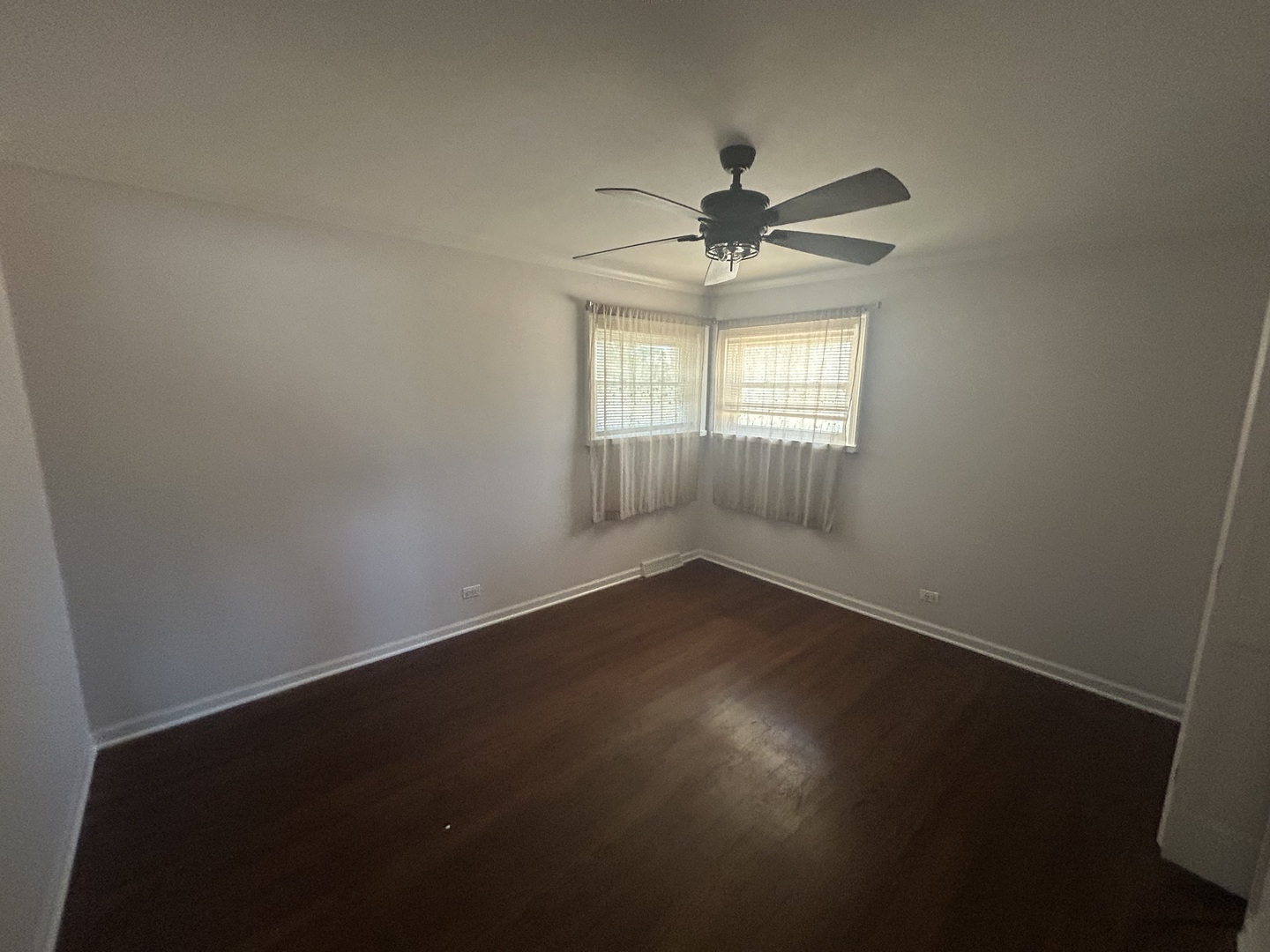 1317 North Mitchell Avenue Arlington Heights, IL 60004 - Photo 11 of 16 an empty room with wooden floor fan and windows