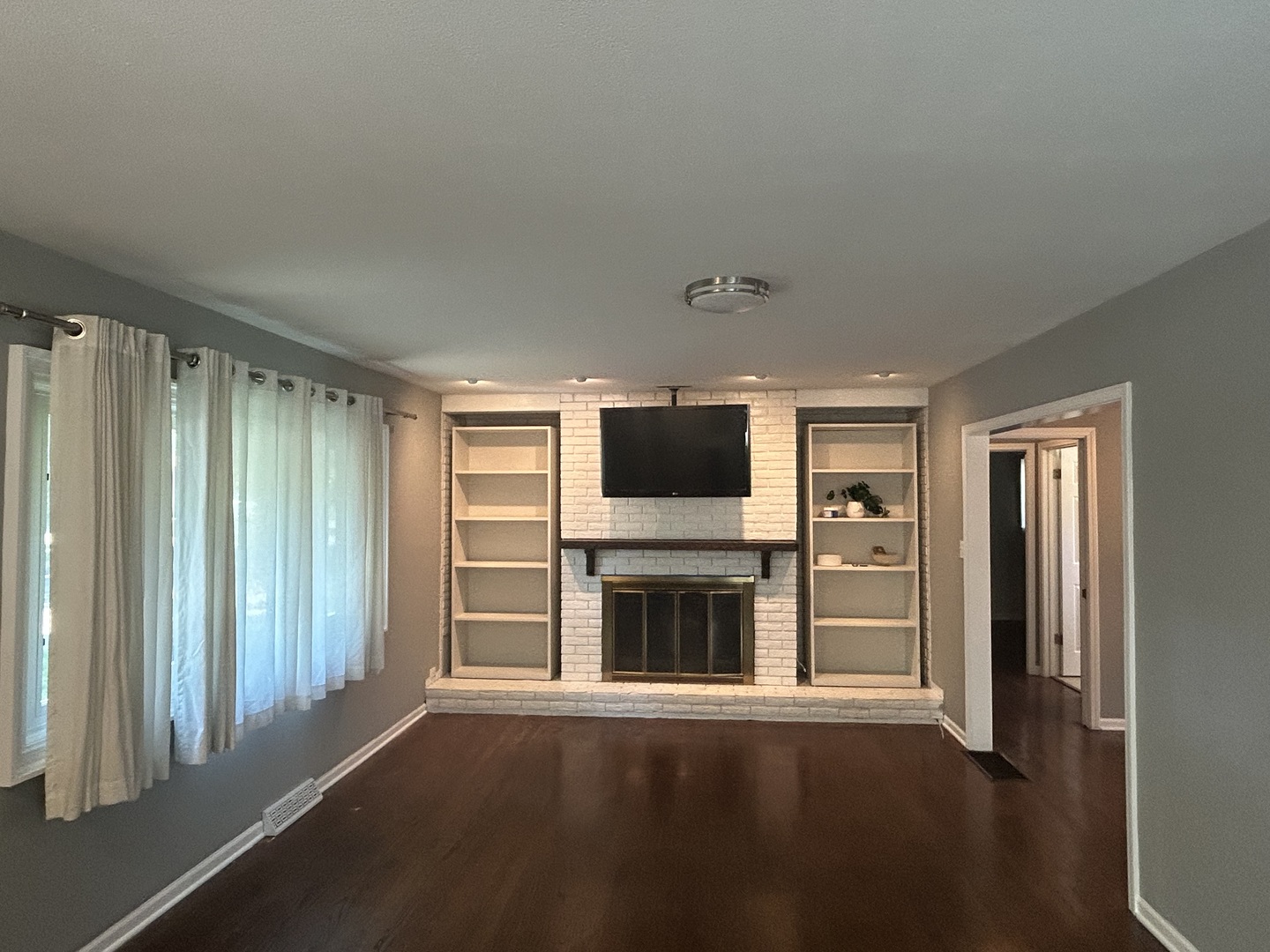 1317 North Mitchell Avenue Arlington Heights, IL 60004 - Photo 3 of 16 a living room with furniture a flat screen tv and refrigerator