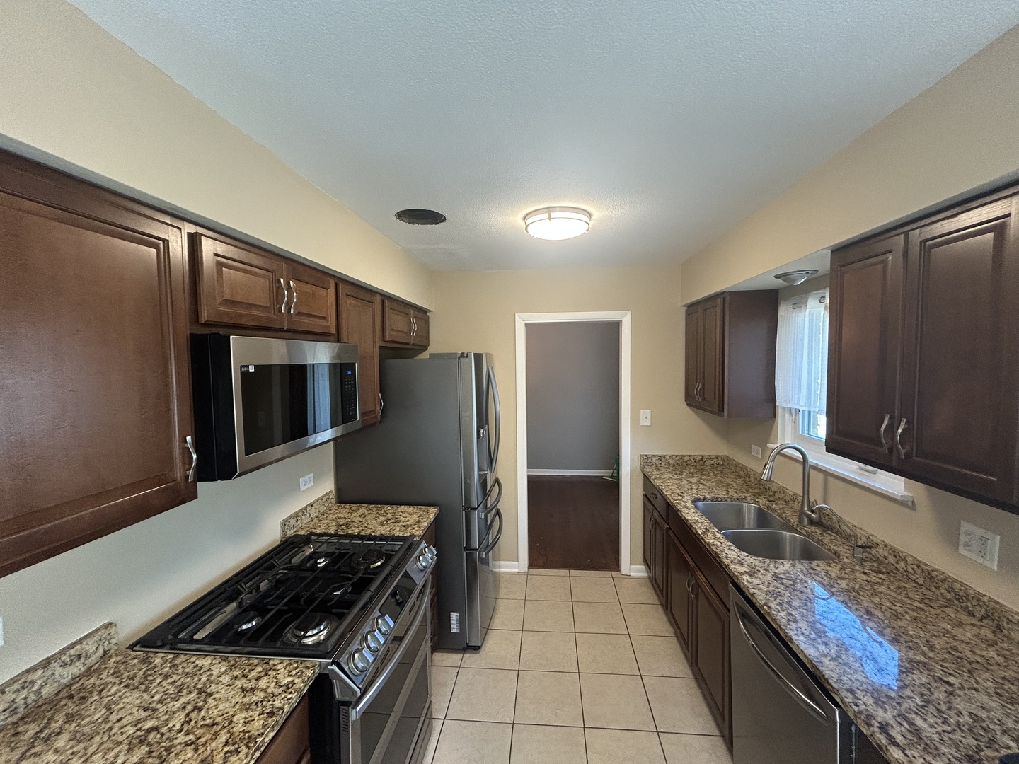 1317 North Mitchell Avenue Arlington Heights, IL 60004 - Photo 6 of 16 a kitchen with stainless steel appliances granite countertop a refrigerator and a stove top oven