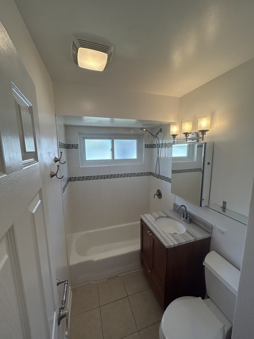 1317 North Mitchell Avenue Arlington Heights, IL 60004 - Photo 9 of 16 a bathroom with a granite countertop sink toilet and shower