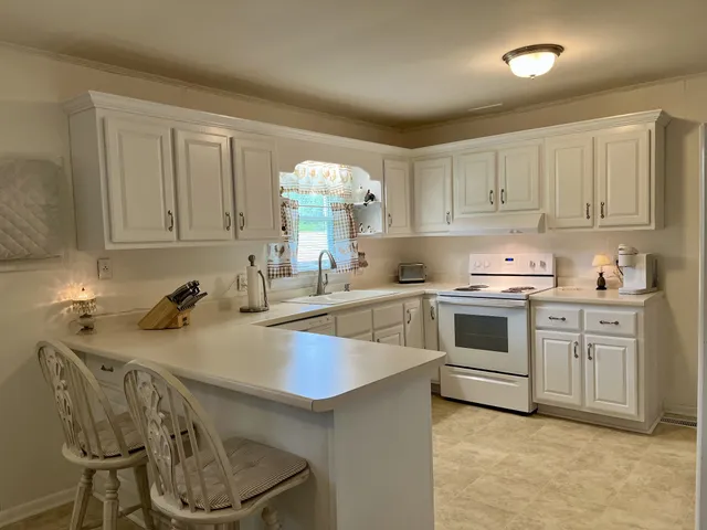 a kitchen with a sink stove and cabinets